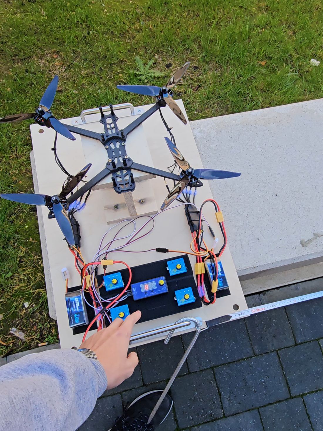 The four-motor rig from above, 7 in tri-blade propellers, servo testers and two batteries on the panel